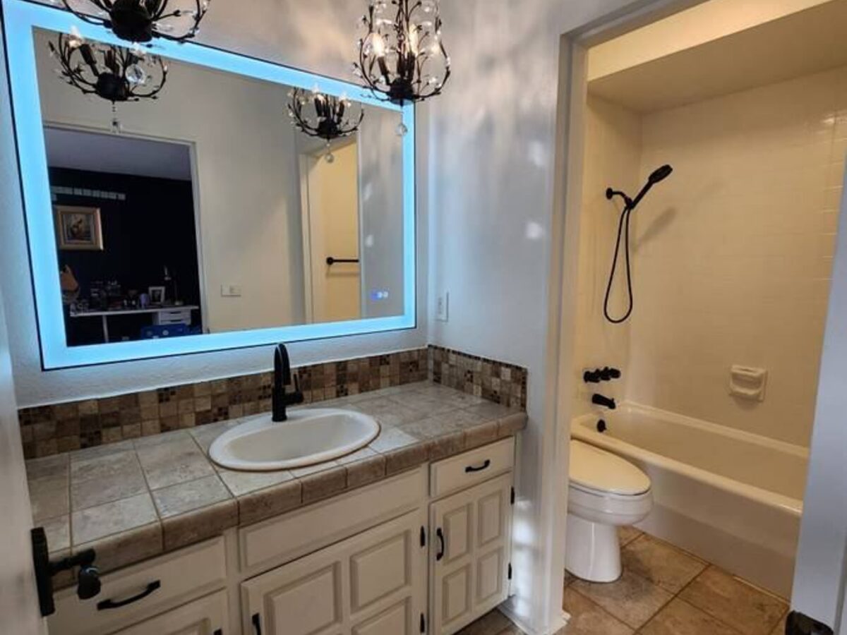 Bathroom after renovation — new vanity lighting and fixtures