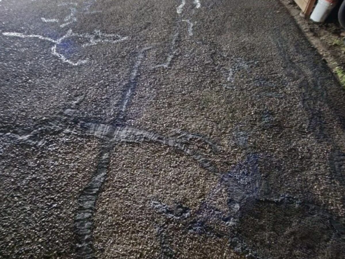 Driveway before resurfacing — cracked and worn