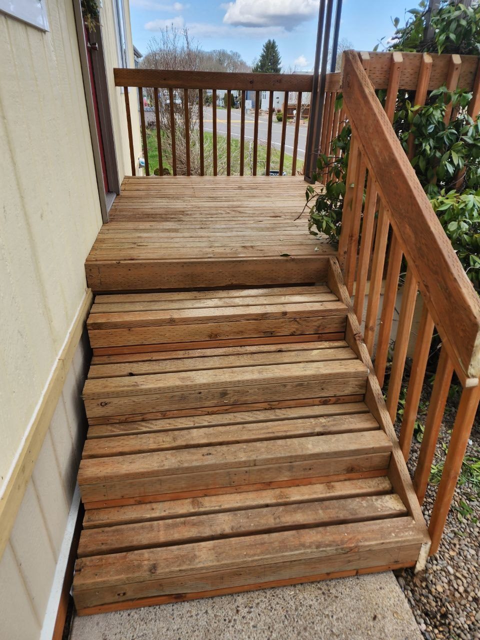 Front porch stairs after remodel — rebuilt with new wood and natural stain